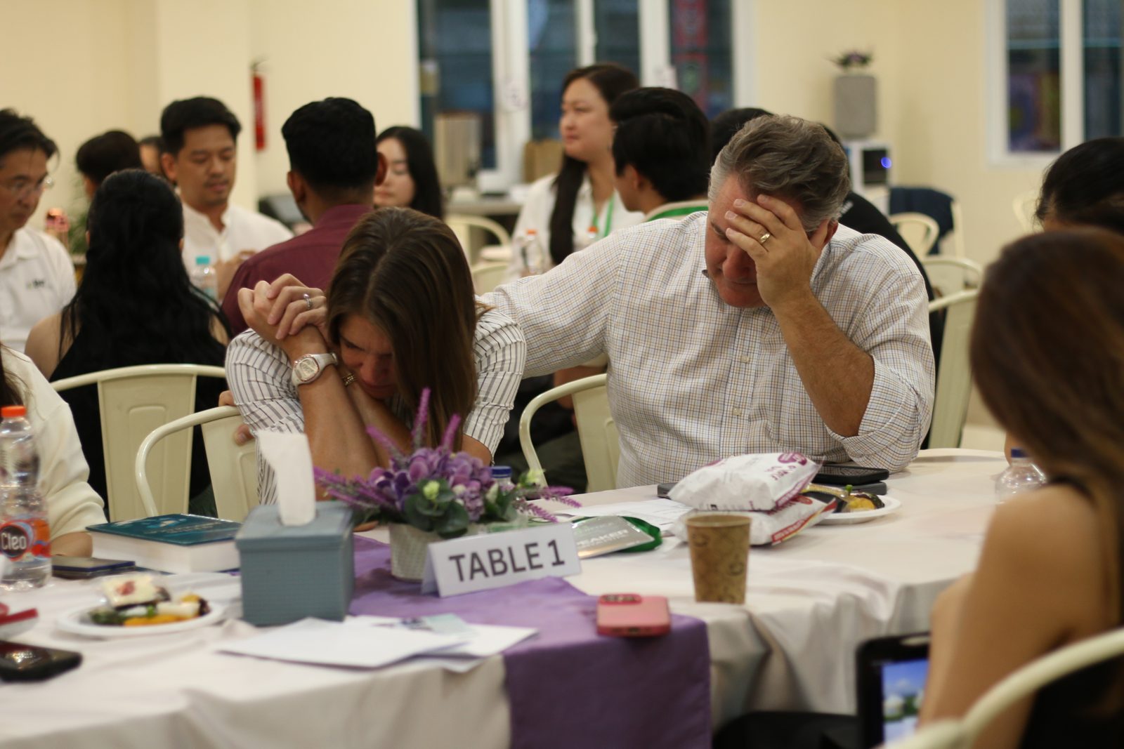 A guest laughing during a conversation at the table