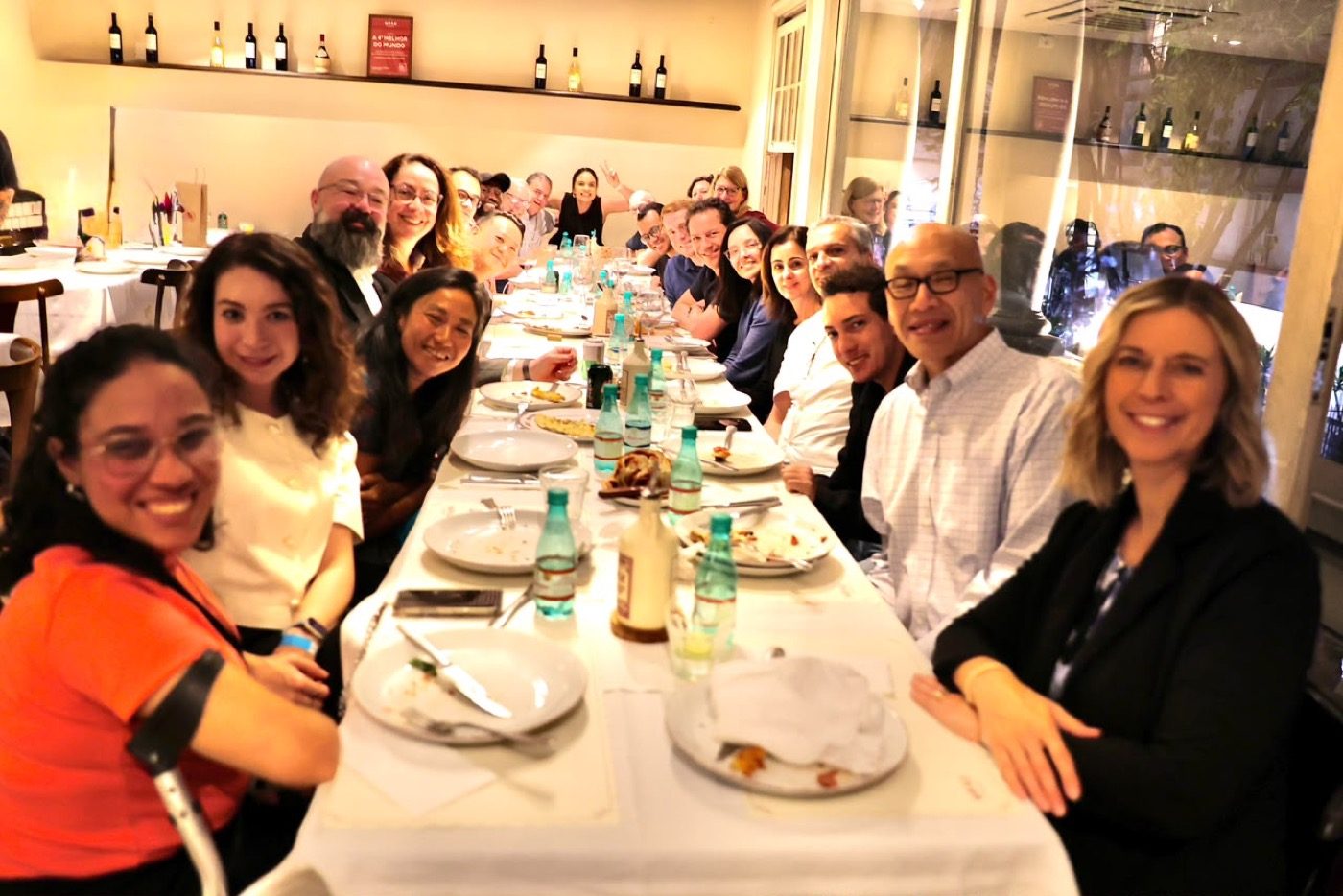 Guests gathered around a long dinner table