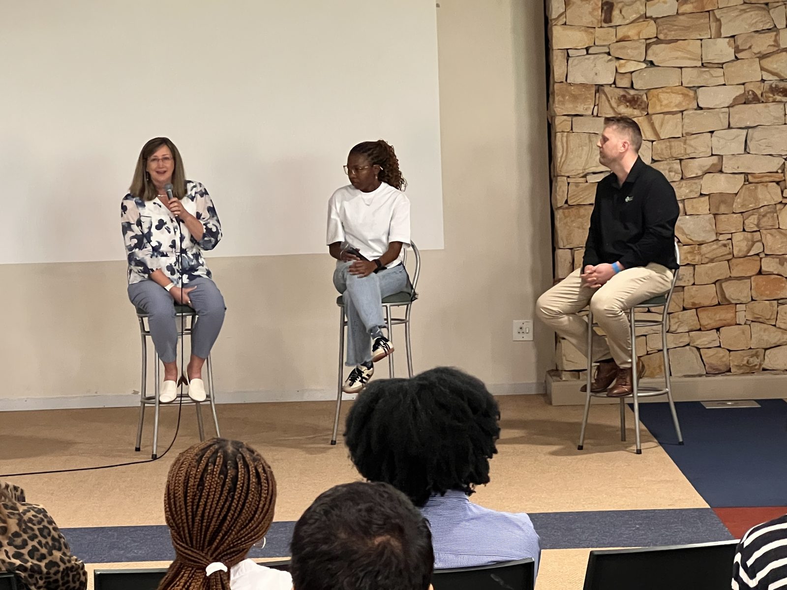 A panel discussion beside the Make Your Work Matter banner