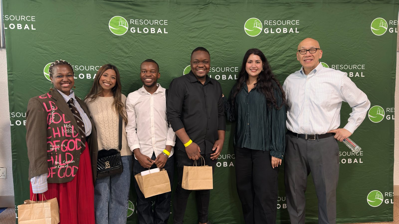 A group at the Resource Global backdrop